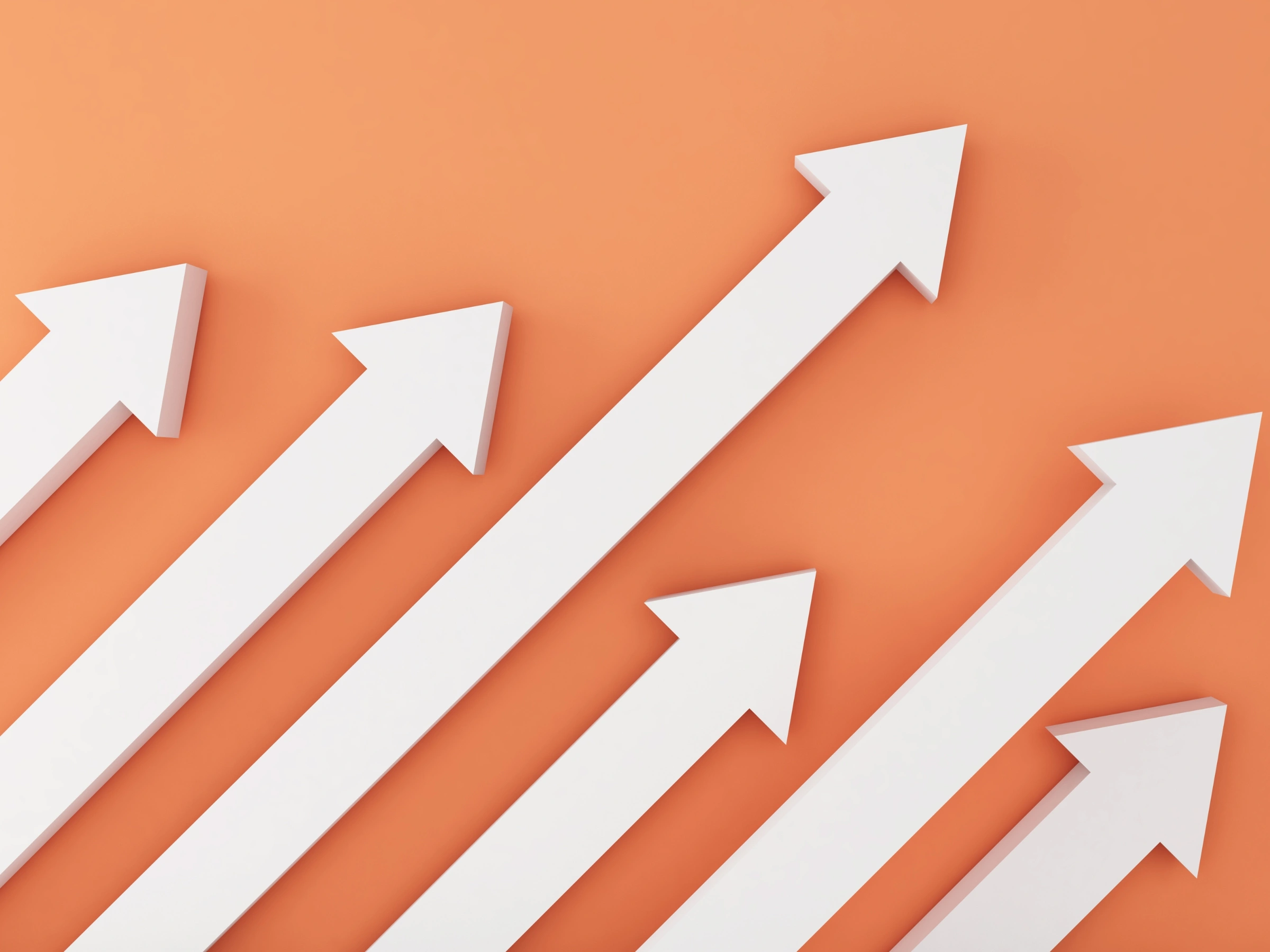 White 3D arrows pointing upward on an orange background, symbolizing growth and progress.