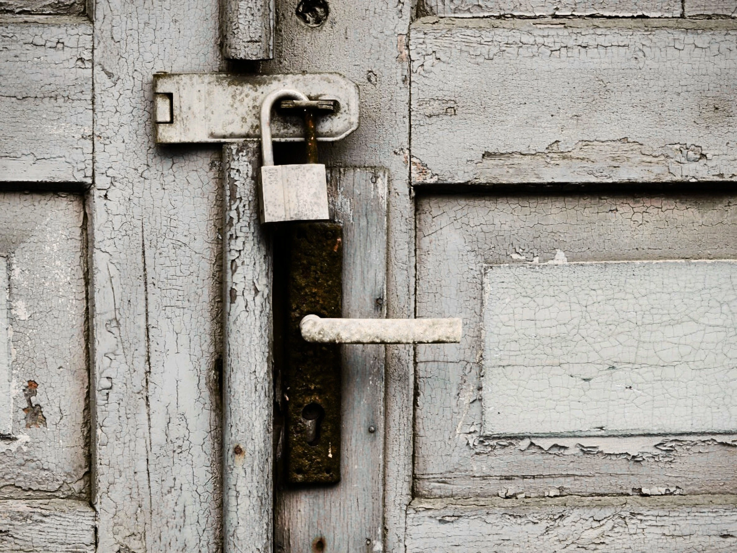 Picture of a locked door with a padlock on it.