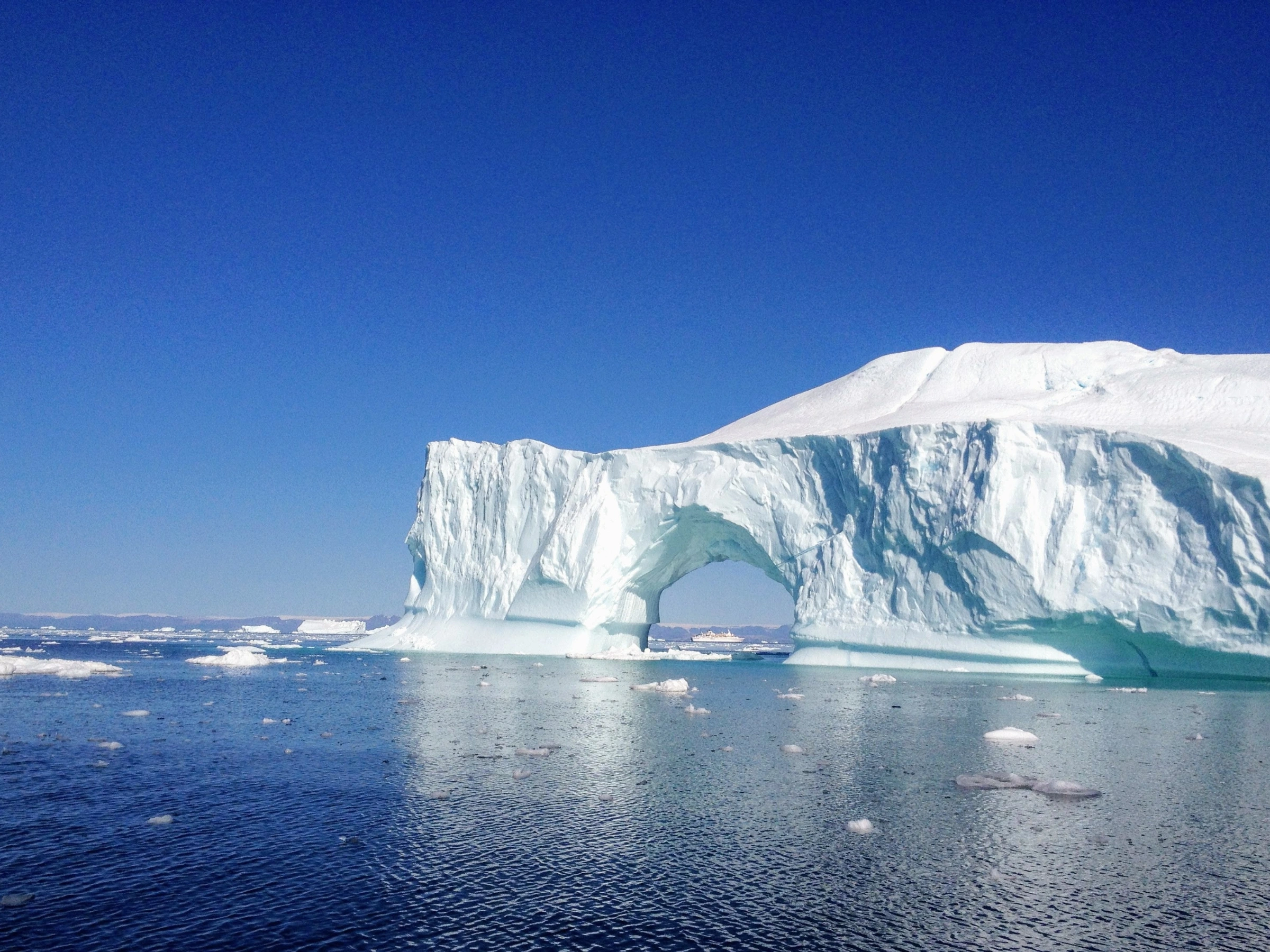 Photo of a large iceberg with a bridge gap.